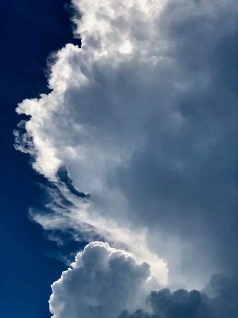A cloud wall in profile, sculpted by wind
