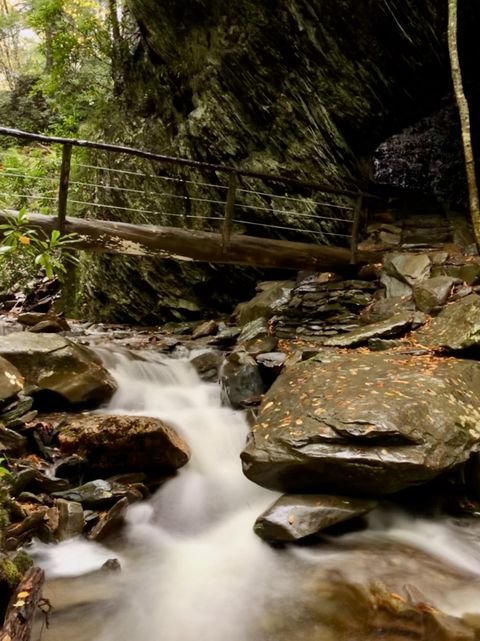 A footbridge over a cascading creek on the descent