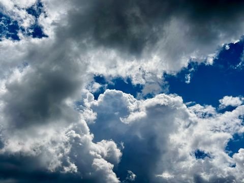 Cumulus towers building over the basin on a blue afternoon