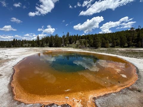 A hot spring ringed in orange, deep blue at the throat